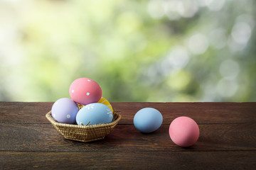 Shot of decoration Happy Easter holiday background concept.Arrangement bunny eggs on the modern rustic brown wooden table at home office desk with green nature backdrop.Negative space for creative.