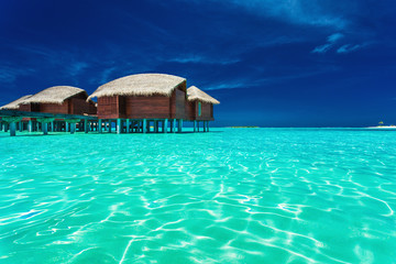 Over water bungalows with steps into lagoon