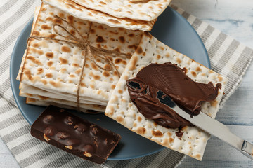 Jewish matzah bread with chocolate cream and knife. Tasty snack for Passover