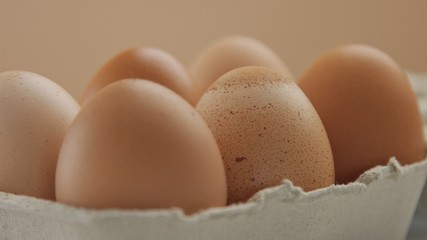 closeup of six brown eggs with different shel texture