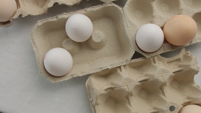 top view of eggs in boxes. Many different eggs with different shell color and texture