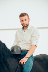 man riding brown horse on the countryside
