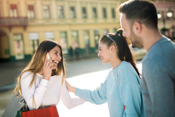 Happy friends shopping. Young friends enjoying shopping in the city.