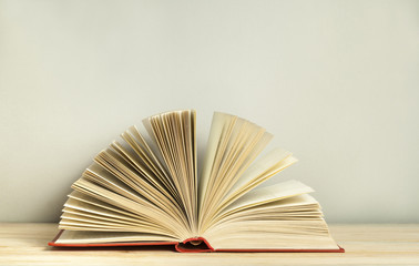 Open book on wooden table. Education background. Back to school. Free copy space.