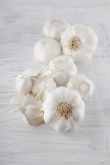 Fresh garlic decorated on a white wooden kitchen plate can be used as background