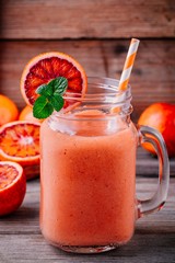 Fresh smoothie with  banana, blood oranges and mint in a mason jar