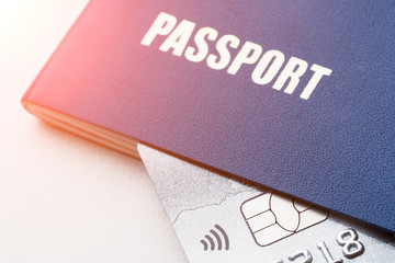 Blue passport with platinum credit card. Closeup, selective focus, toned