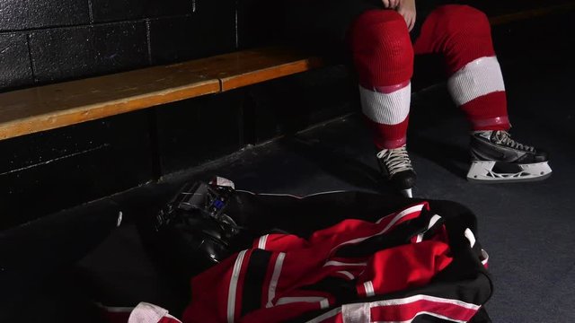 Hockey Player Throws Equipment Into Bag