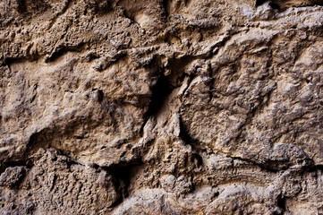 Close up Textured background of a wall of medieval stone masonry. The wall is sloppy built of mountain stones. Medieval style
