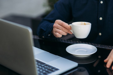 The young manager working on a laptop on coffe break. Lunch Break.