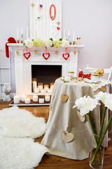 A cute white and red room with lots of heart-shaped decoration for a very special day for the in-loved. Interior decorated for of St. Valentine's Day.