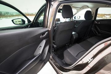 Fototapeta na wymiar Black car interior with back seats