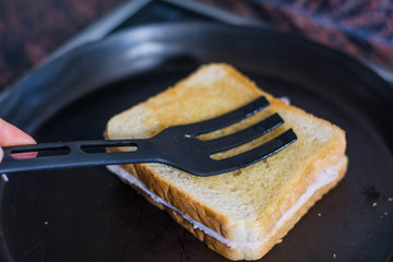 making a sandwich in a pan, in a frying pan with butter and sandwich bread, grilled in the pan
