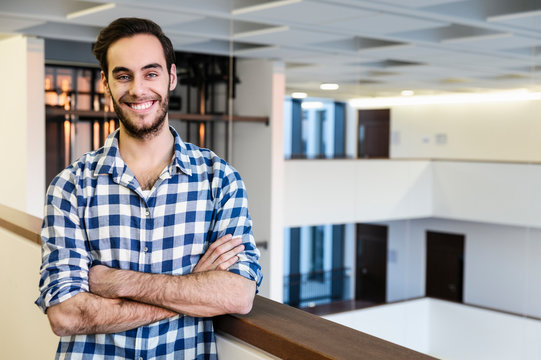Portrait of confident young businessman in office atrium