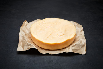 Whole round Head of parmesan or parmigiano hard cheese on concrete background