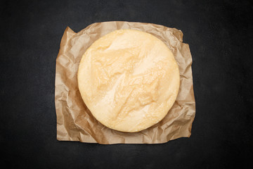 Whole round Head of parmesan or parmigiano hard cheese on concrete background