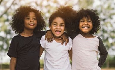 Children Friendship Togetherness Smiling Happiness Concept.Cute african american little boy and girl hug each other in summer sunny day