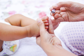Mother Cutting Her Babies Nails
