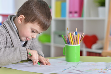 little boy drawing with pencil