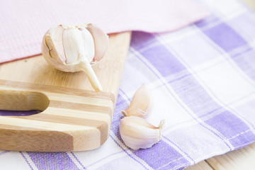 Set of raw ingredients for Italian cooking on a table. Garlic on a cutting board. Set of healthy food products. Closeup, top view