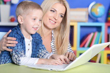 Fototapeta premium Mother and son using laptop