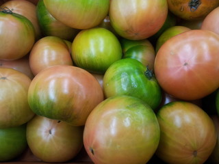 Red tomatoes in red basket in market