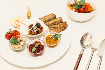Vegetarian food with cutlery on white table