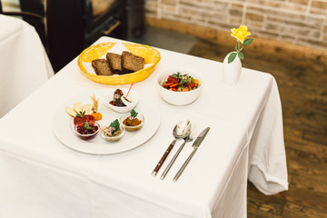 Vegetarian food with cutlery on white table