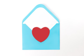 White envelope with  red heart for valentine's day or love mail. Flat lay.  Creative message
