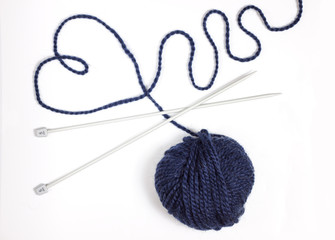 Balls of wool soft yarn with needle for knit on the white wooden background. Copy space for text