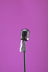 vintage microphone on a purple isolated background