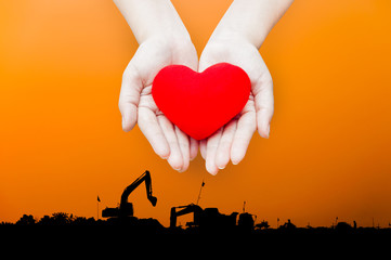 Close up Red heart in woman hands, isolated on industry energy landscape background,health, medicine, people and cardiology concept,energy concept