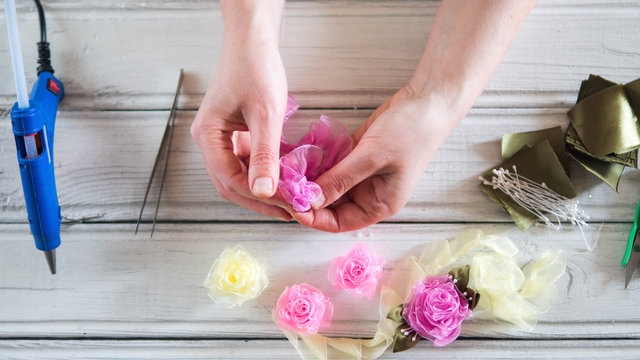 Woman doing kanzashi of satin ribbons. Women's handicrafts. Kanzashi ribbons.
