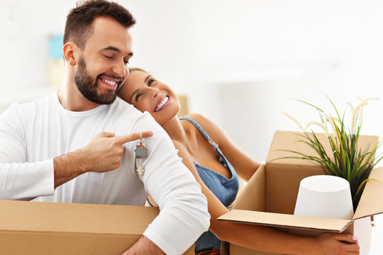 Happy Adult Couple Moving Out Or In To New Home