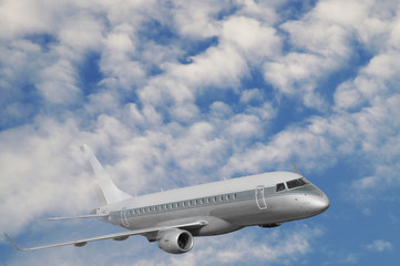 Fototapeta premium The passenger plane during the flight rises above the cloud level