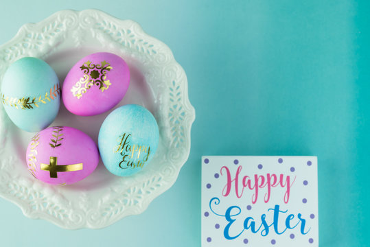Easter decorated eggs on white plate. Greeting card.