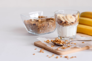 Ingredients for homemade oatmeal granola in glass jar. Oat flakes, honey, raisins and nuts. Healthy...
