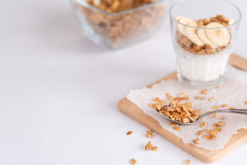 Ingredients for homemade oatmeal granola in glass jar. Oat flakes, honey, raisins and nuts. Healthy breakfast concept with copy