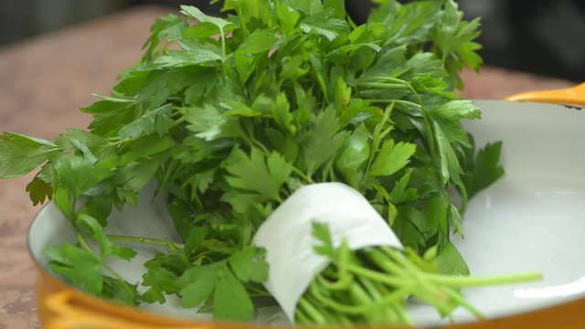 Bunch of bio persil in a professional kitchen ready to be cut for a delicious beef tartar.
