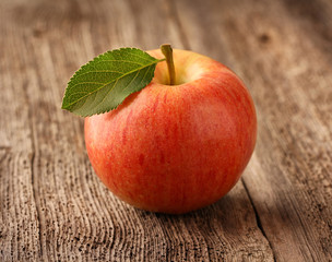 Red apple on wooden background