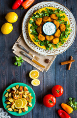 Chicken nuggets with yogurt sauce on a wooden background