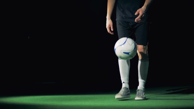 Football palyer preforms impressive dribbling tricks.