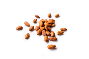 pile of roasted organic almonds with the peel isolated on a white background. Horizontal composition.
