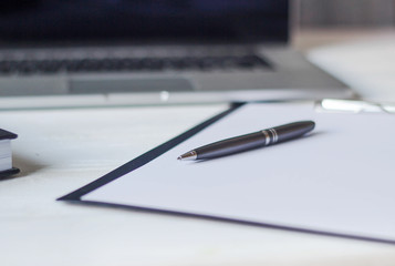 laptop and documents in the workplace.