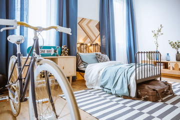 Bicycle in blue bedroom interior