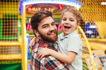 Cheerful little boy having fun with his dad