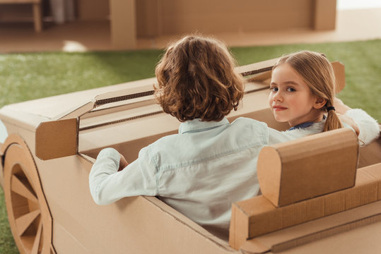 Little Kids Riding Cardboard Car