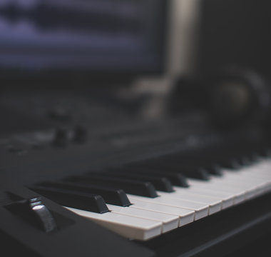 Midi keyboard and pc with music software. Concept of home music studio.