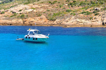 Fototapeta na wymiar boat on a beautiful blue sea near the coast in Corsica