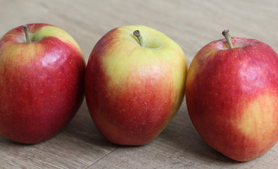 red and yellow Jazz apples on wooden background